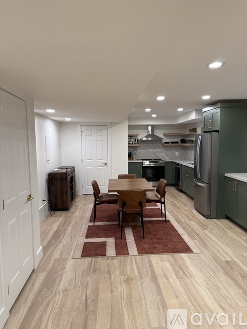 A kitchen with a table and chairs in the middle of the room.