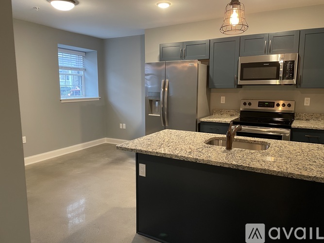 A kitchen with granite countertops and stainless steel appliances.