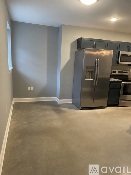 A kitchen with a stainless steel refrigerator and oven.
