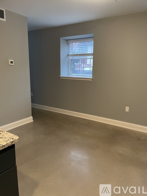 A room with a window and a counter.