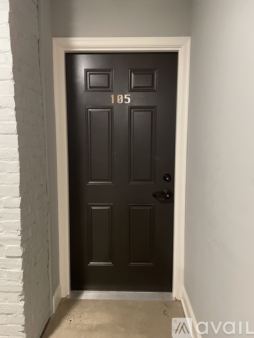 A black door with the number 105 on it.