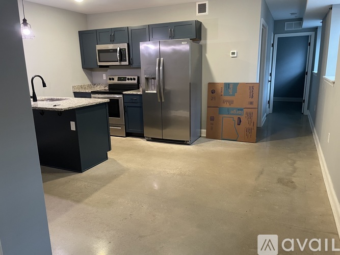 A kitchen with a refrigerator, oven, and microwave.