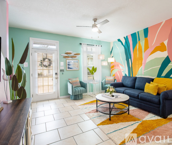A living room with a blue couch and a coffee table.