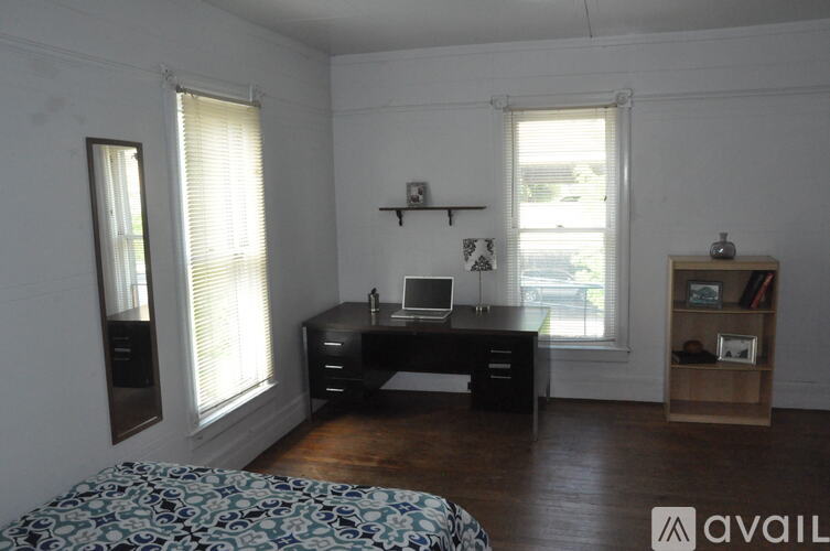 A room with a desk and a chair in it.