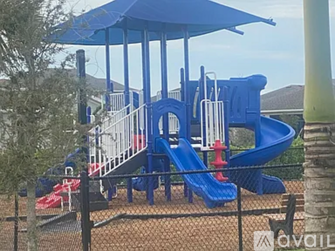 A playground with a blue slide and a red slide.