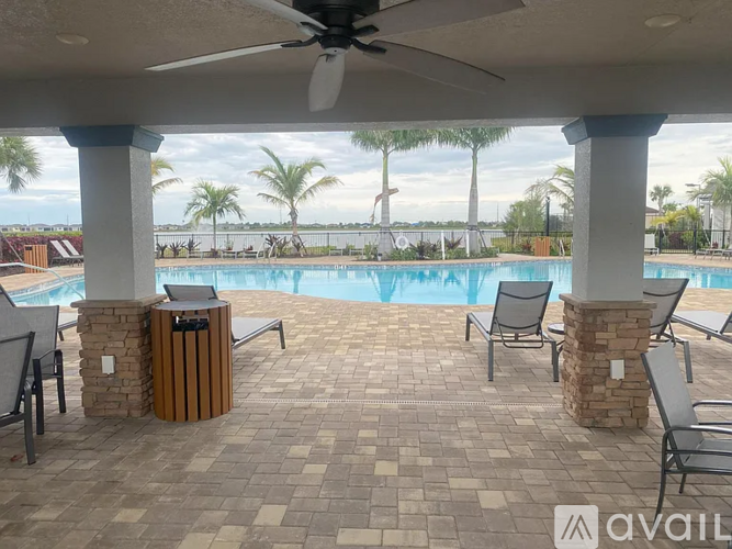A patio with a pool and a fan.