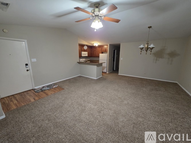 A room with a ceiling fan and a chandelier.