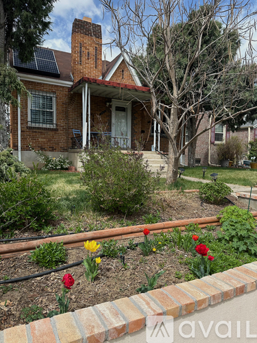 A house with a garden in front of it.