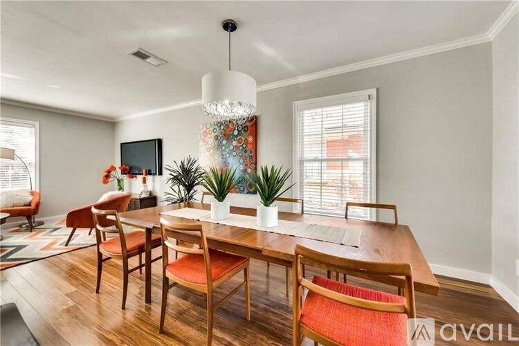 A dining room with a wooden table and chairs.
