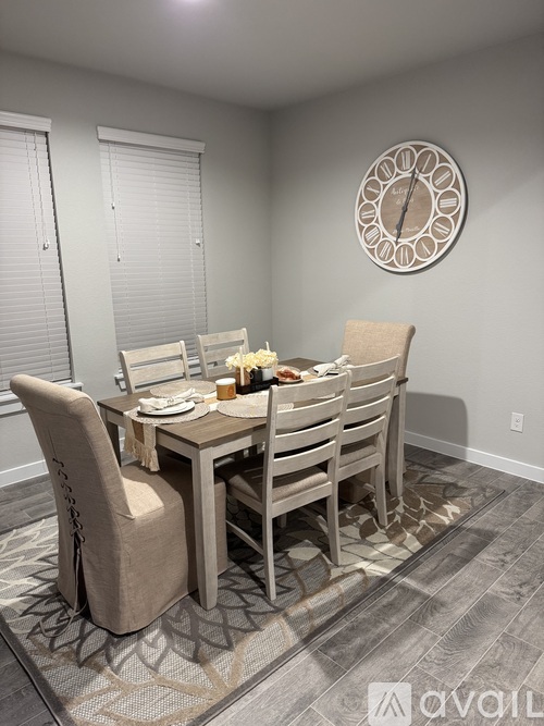 A dining room with a table set for four.