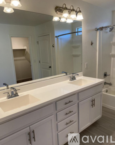A bathroom with two sinks and a large mirror.