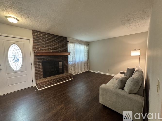 A living room with a fireplace and a couch.
