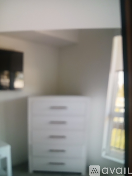 A white drawer cabinet sits in a room.