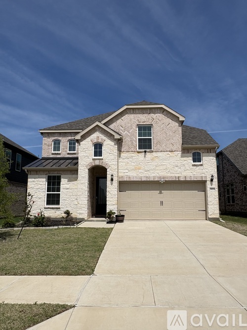 A house with a garage and a driveway in front.