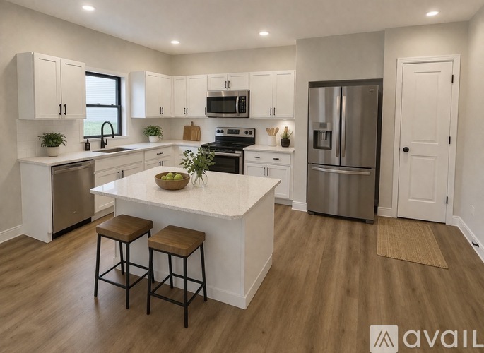 A modern kitchen with white cabinets and a central island.