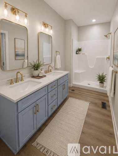A bathroom with a white sink and blue cabinets.