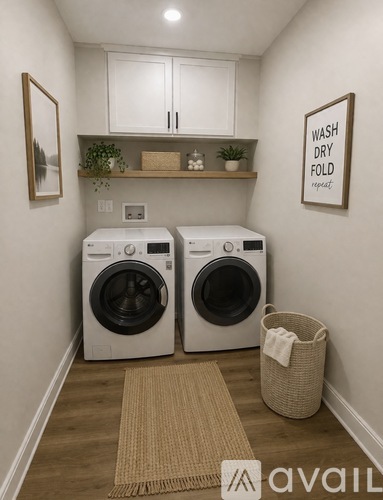 A laundry room with two washing machines and a sign that says "Wash Dry Fold Repeat".