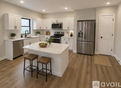 A modern kitchen with white cabinets and a central island.