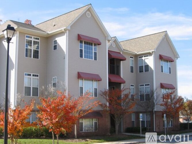 Apartment building with trees in front of it.
