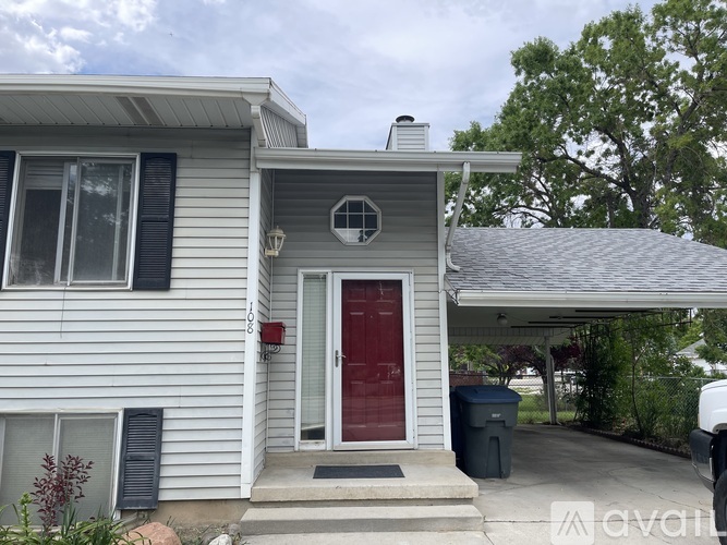 A house with a red door and a garage door opener.