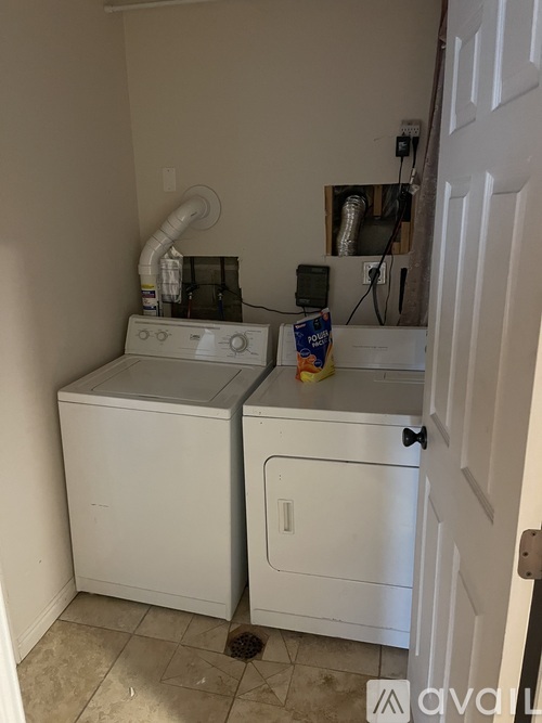 A white washer and dryer in a small laundry room.