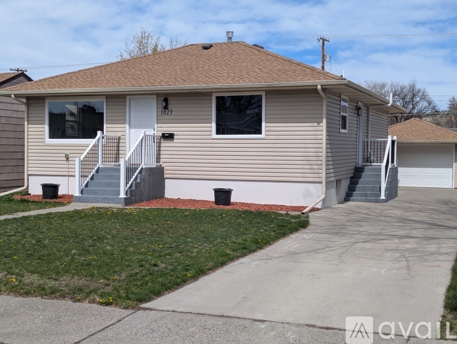 A house with a brown roof and a white door is numbered 13.