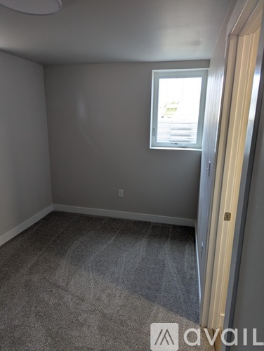 A room with a carpeted floor and a window.