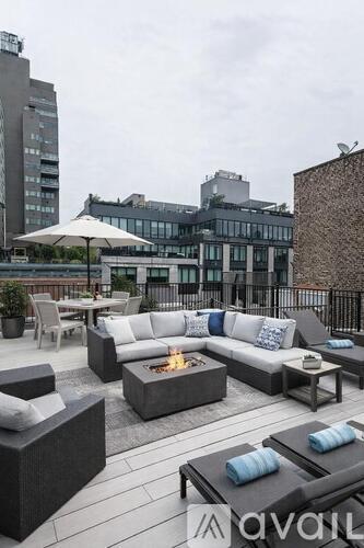 A patio with a fire pit and seating area.