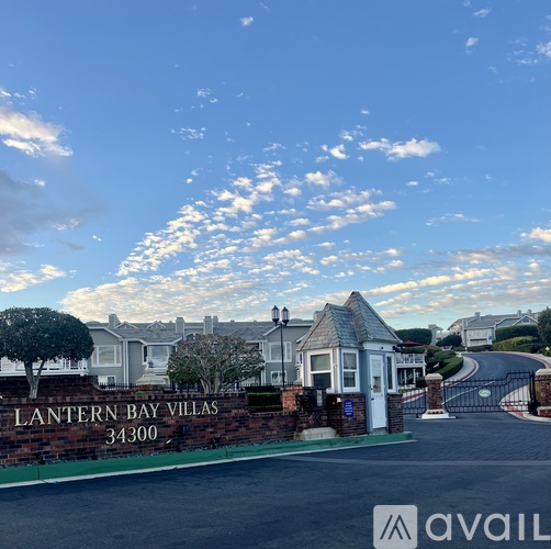The image shows a beautiful day at the Lantern Bay Villas with a clear blue sky and a few clouds.