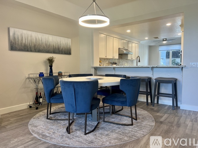 A dining room with a table and chairs.