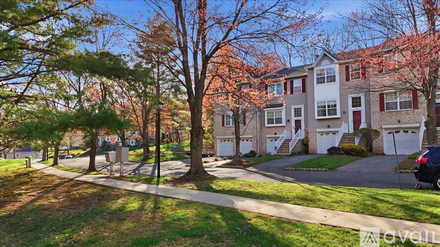 A row of houses with trees in front of them.