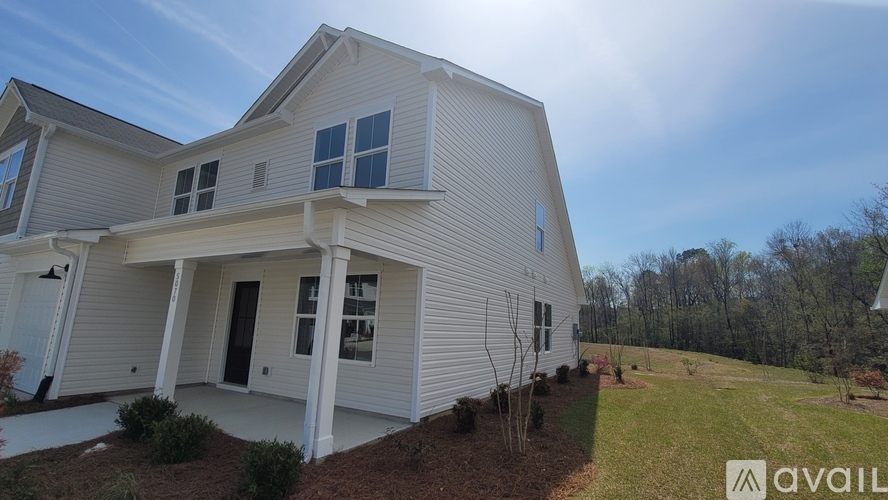 A house with a white exterior and a large front porch.