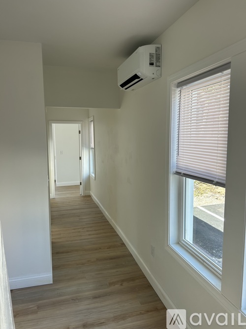 A long hallway with a window on the right side.