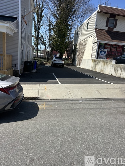 A street view with a car parked on the side of the road.