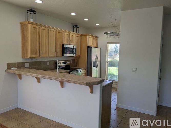 A kitchen with wooden cabinets and a countertop.