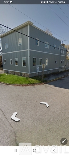 A grey building with a white sign on the front.