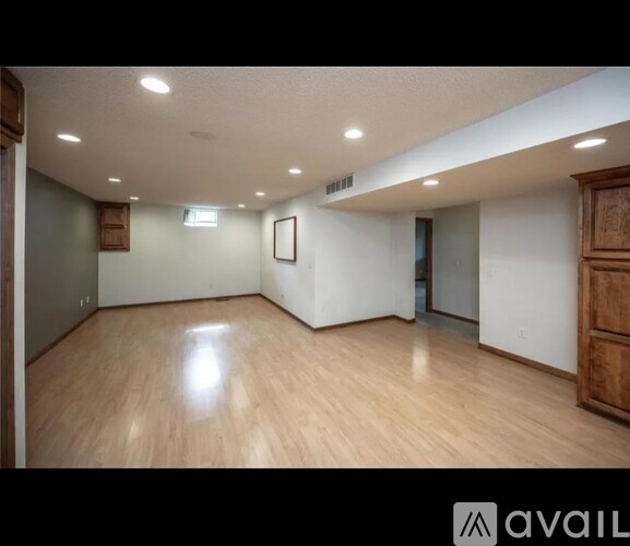 A room with wooden floors and white walls.