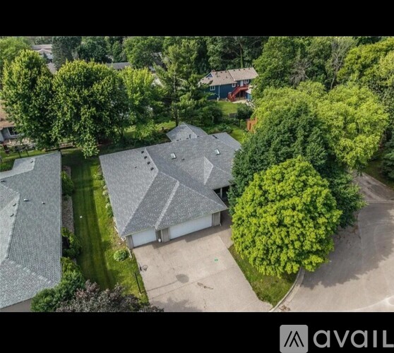 A bird's eye view of a residential area with houses and trees.