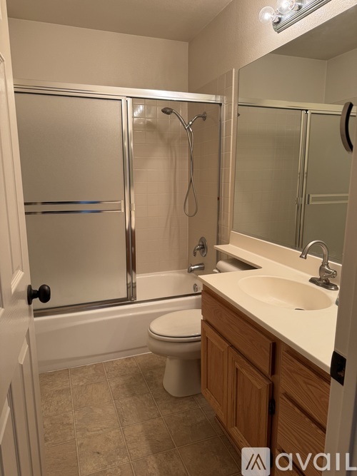 A bathroom with a toilet, sink, and shower.