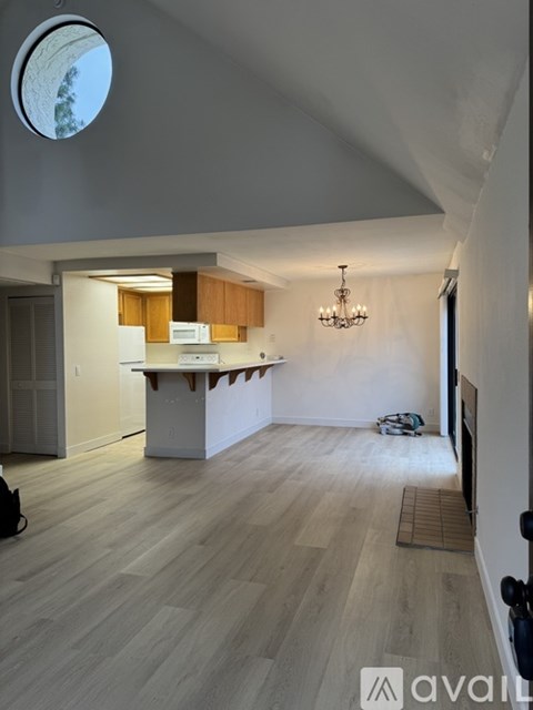 A modern kitchen with wooden cabinets and a white island.