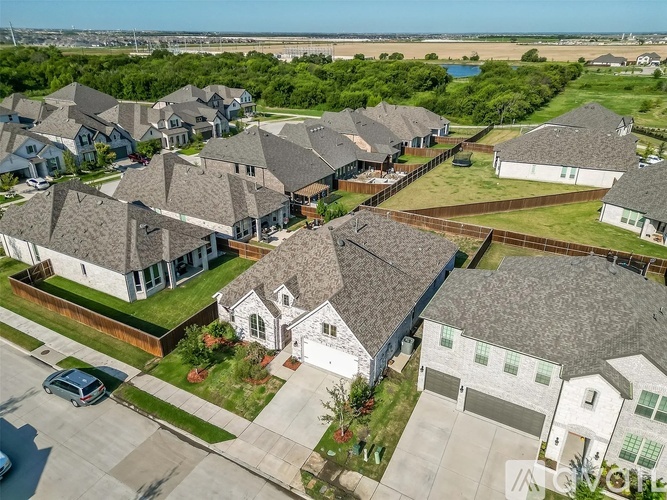 A bird's eye view of a residential neighborhood with houses and cars.