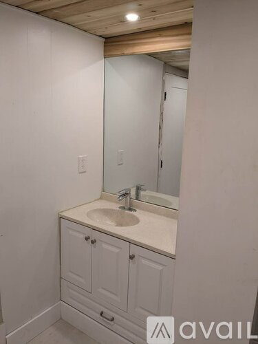 A bathroom with a sink and a mirror.