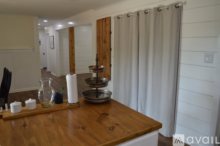 A kitchen counter with a wooden top and a few items on it.