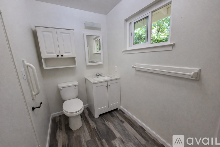 A small bathroom with a toilet, sink, and medicine cabinet.
