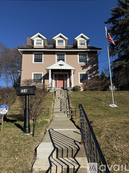 A house with a flag on the lawn.