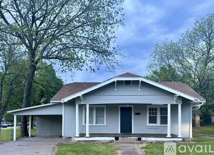 A house with a porch and a covered entry way.