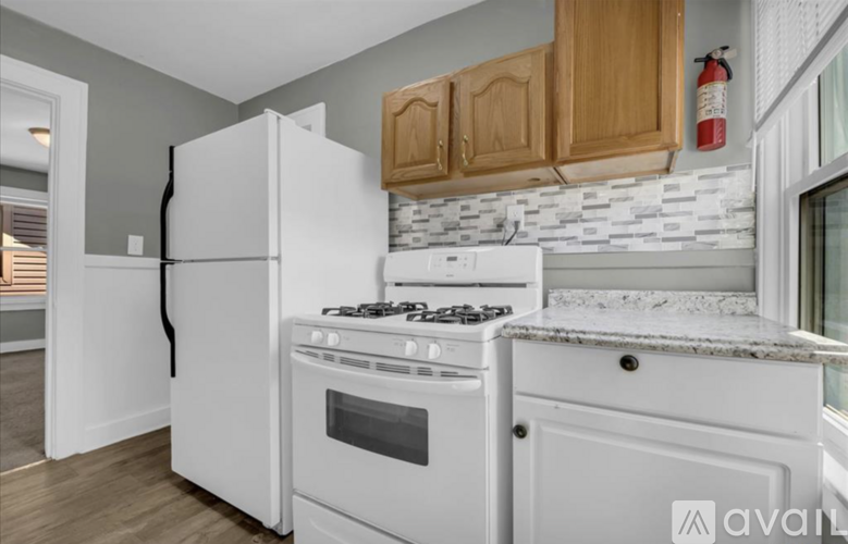 A kitchen with a white refrigerator, stove, and oven.