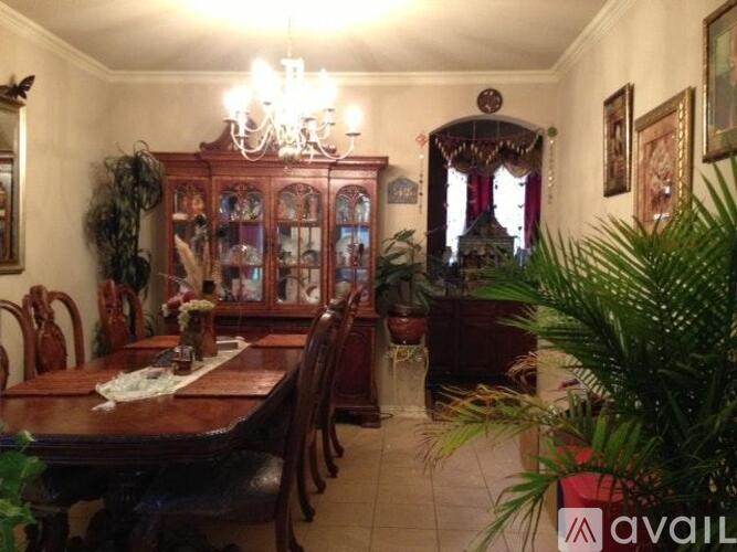 A dining room with a wooden table and chairs.