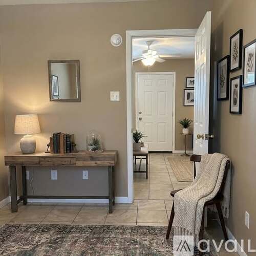 A room with a desk, chair, and a mirror.