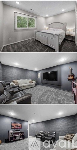 A bedroom with a large bed, a couch, and a television in a living room.